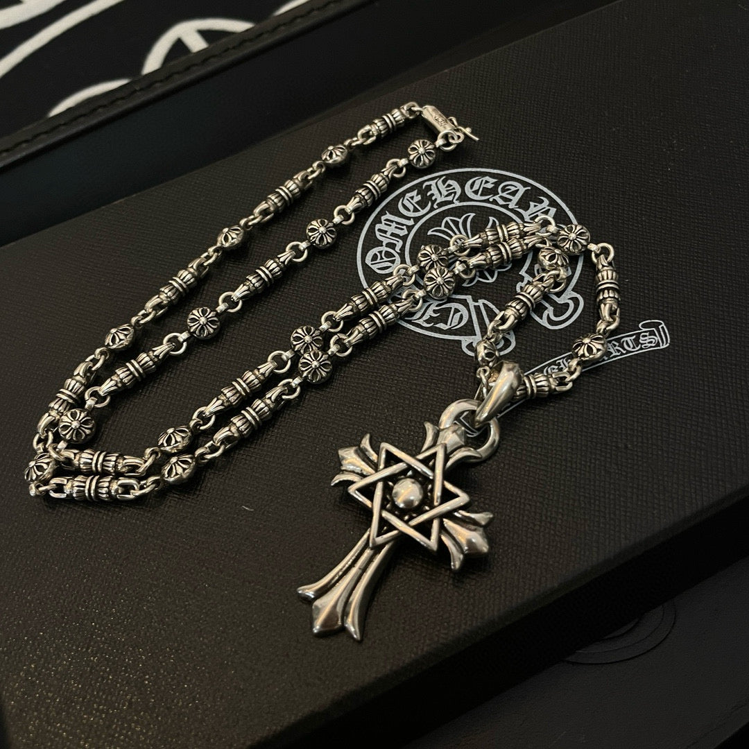 Silver-tone chain necklace with cross star pendant and ornate clasp detail
