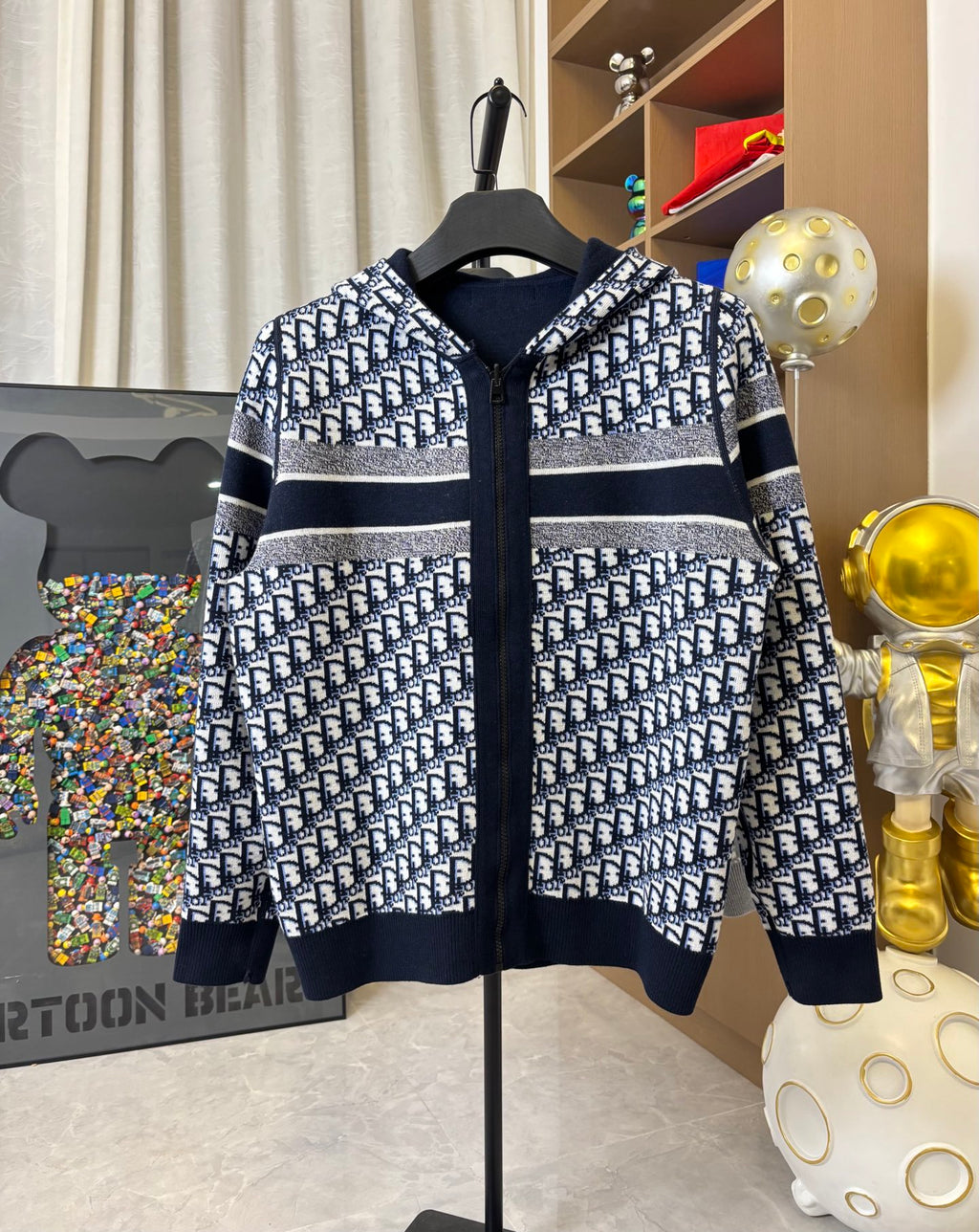 Dior hooded zip jacket with navy-and-white allover pattern, striped bands and hood