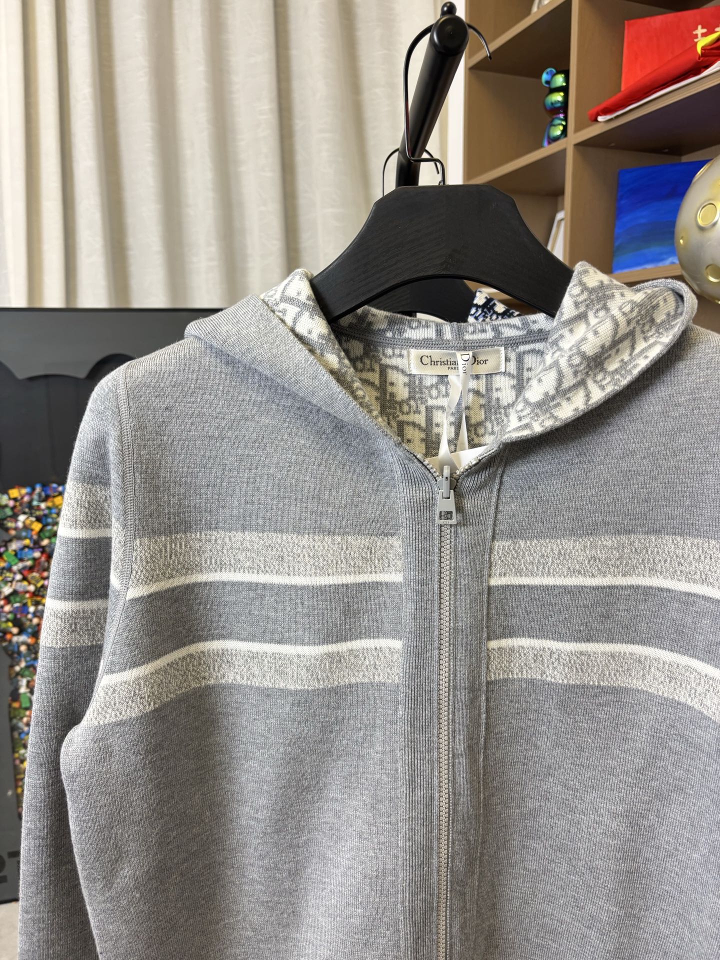 Gray zip-up hoodie with hood and light horizontal stripe detailing