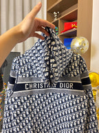 Dior hooded zip jacket close-up with navy-and-white pattern and chest logo stripe