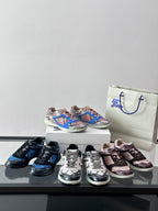 Multiple sneakers on display: blue, black, pink, and multicolor pairs on shoeboxes