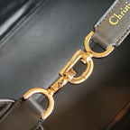 Gold buckle and clasp on Dior strap, dark blue leather with Christian Dior text