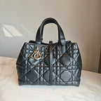 Dior quilted tote bag with gold D-R logo clasp and top handles, dark blue