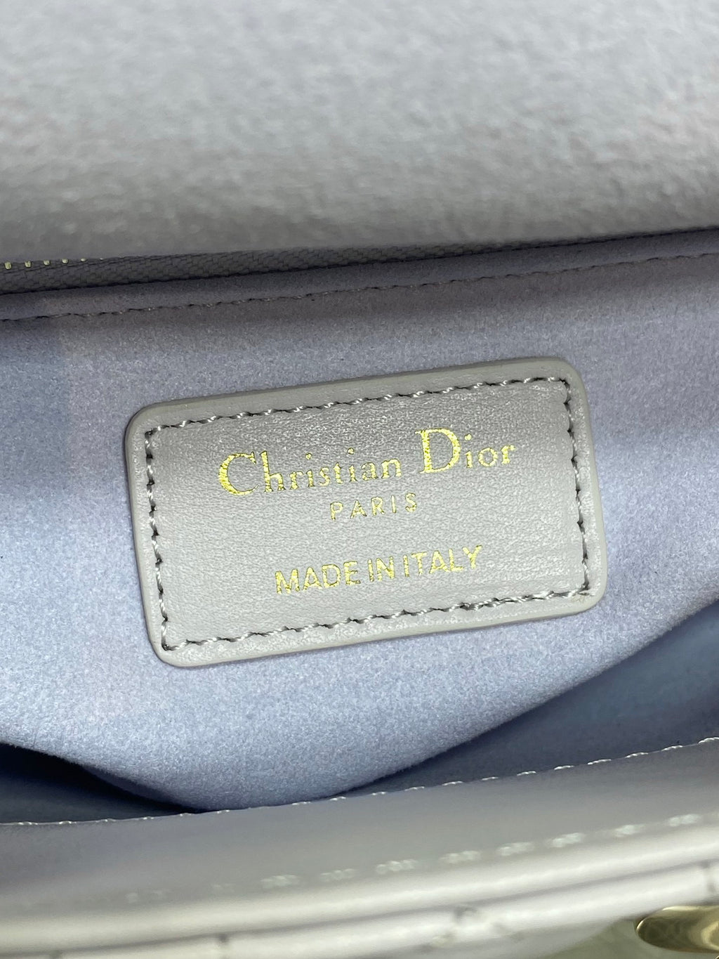 Dior logo label on bag interior reading “Christian Dior Paris” and “Made in Italy”