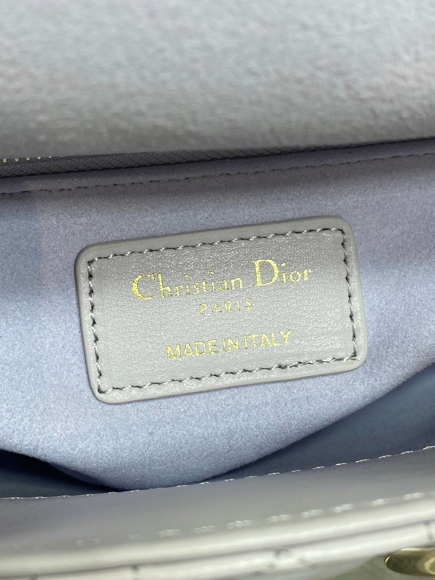 Dior logo label on bag interior reading “Christian Dior Paris” and “Made in Italy”