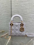 Dior quilted mini bag with top handles, gold hardware, and a detachable chain strap
