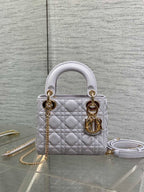 Dior quilted mini bag with top handles, gold hardware, and a detachable chain strap