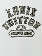White Louis Vuitton T-shirt close-up of embroidered text and emblem graphic