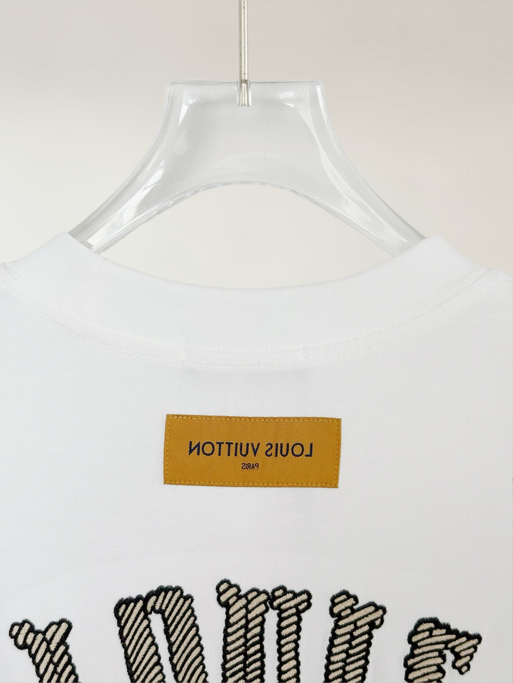 White Louis Vuitton T-shirt back close-up with neck label and top graphic
