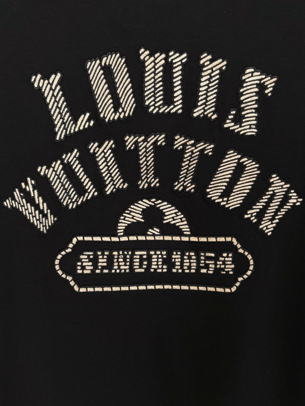 Louis Vuitton short-sleeve T-shirt back graphic with gold outlined emblem