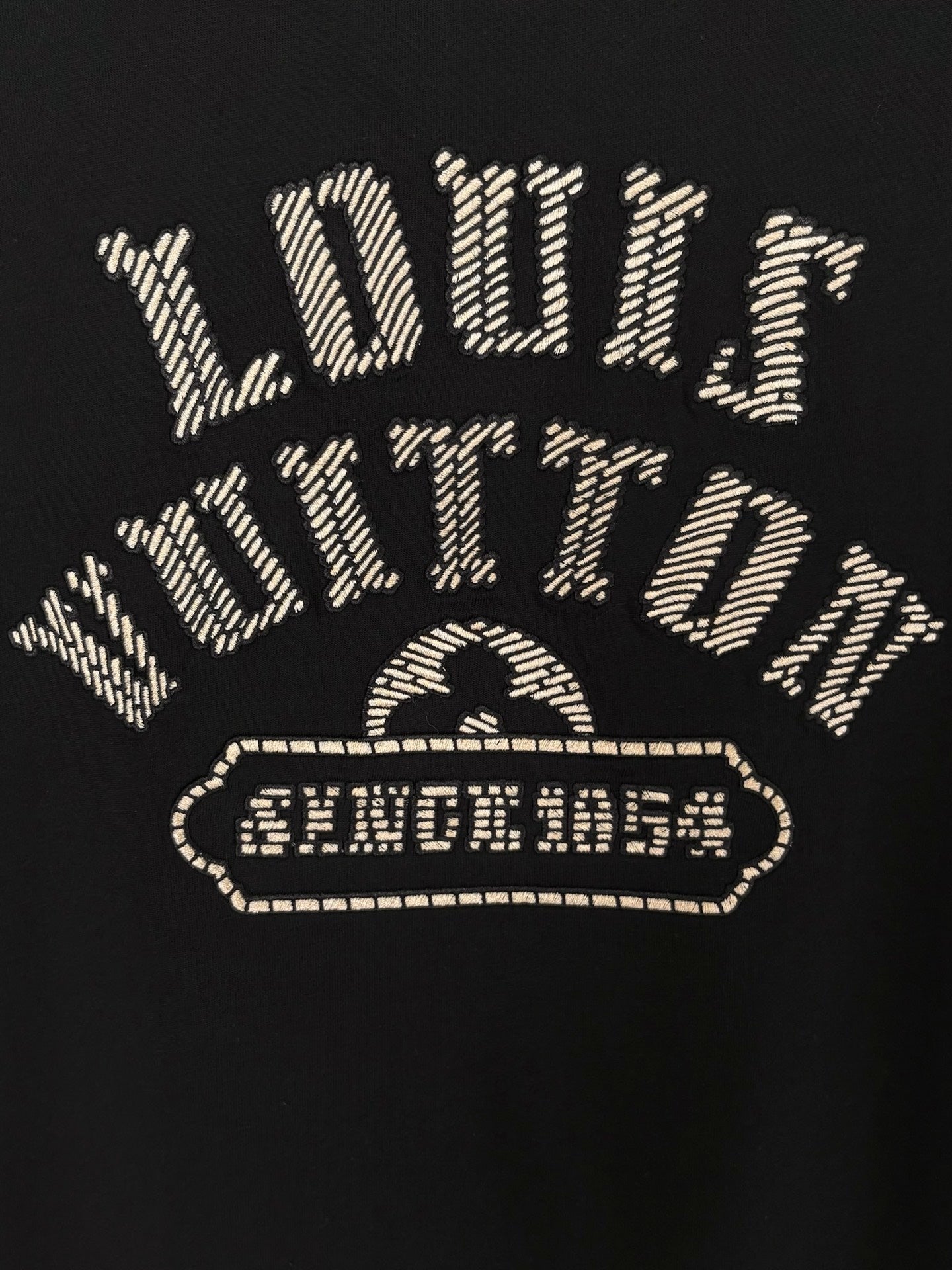 Louis Vuitton short-sleeve T-shirt back graphic with gold outlined emblem