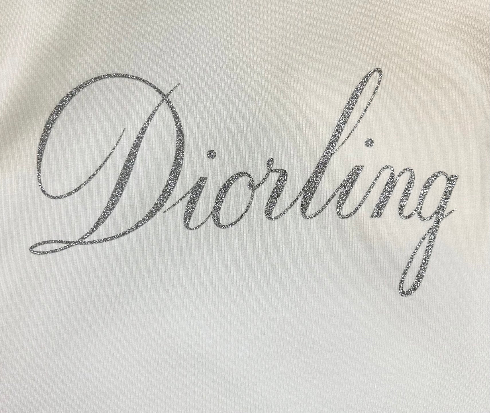 White fabric with 'Diorling' script print