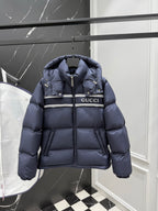 Dark blue hooded puffer jacket with front zipper and Gucci logo stripe