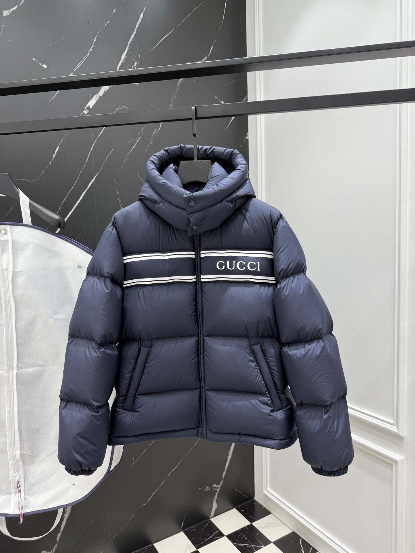 Dark blue puffer jacket with hood, full-zip front and Gucci logo stripe