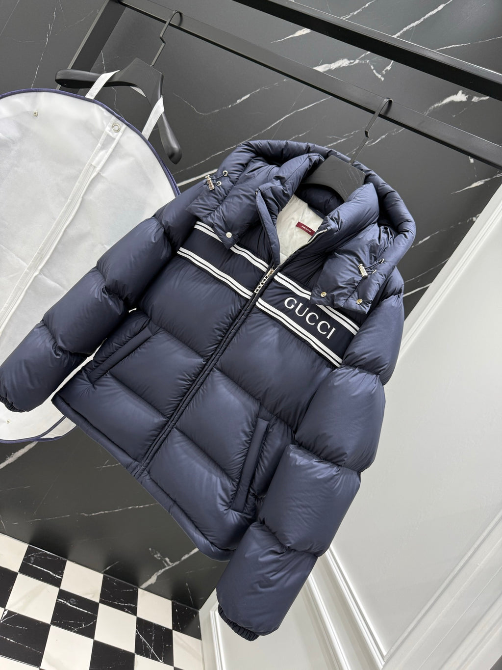 Dark blue long puffer jacket with hood, zipper, Gucci logo stripe and gold accents