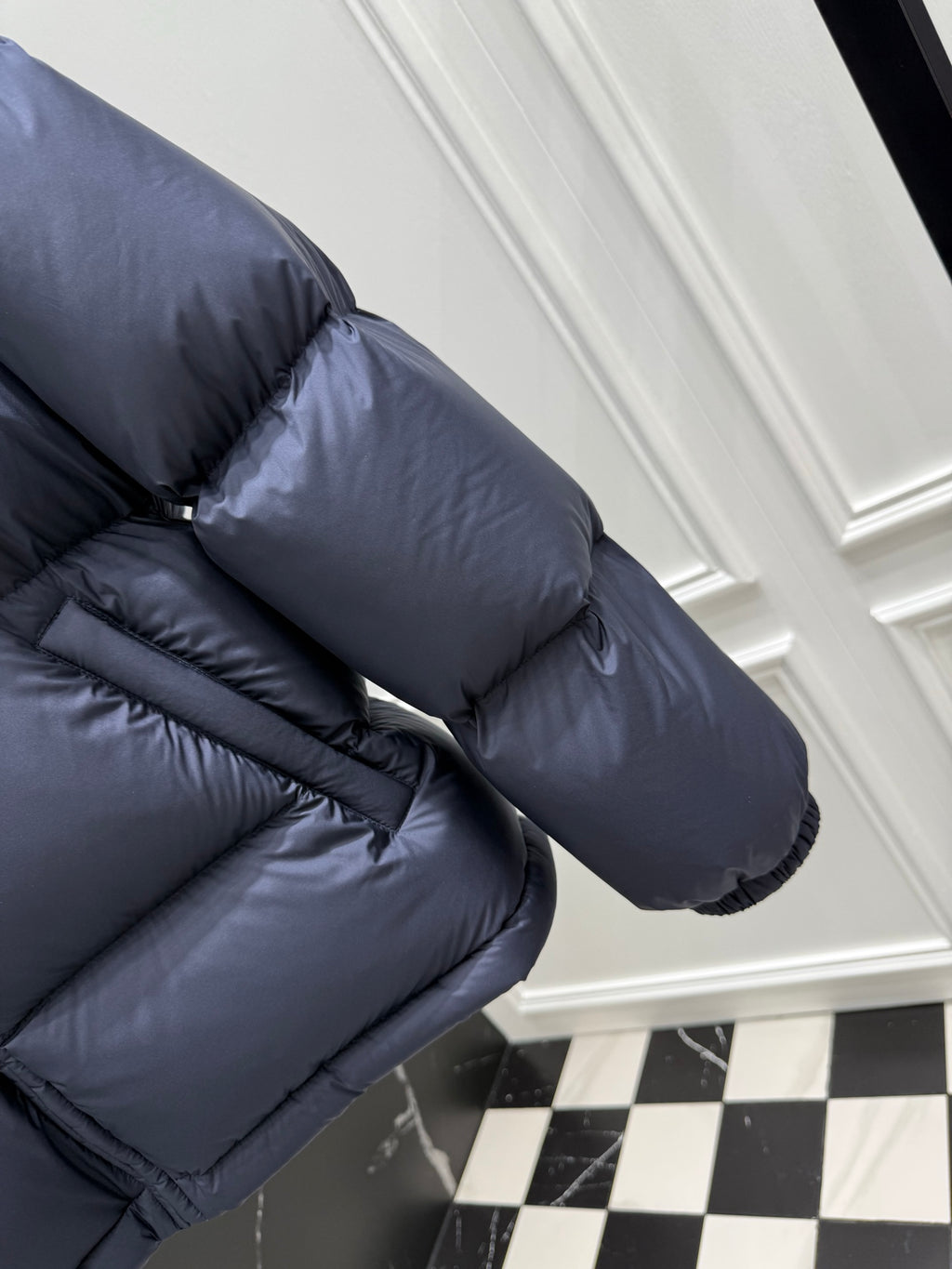 Dark blue puffer jacket sleeve and shoulder with striped Gucci logo band