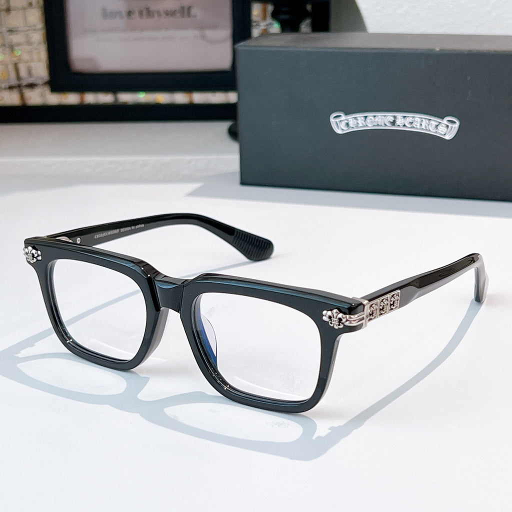 Dark eyeglasses with square frames and gold-tone patterned temple detail
