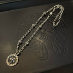 Silver-tone pendant necklace set with circular medallion and ornate chain links