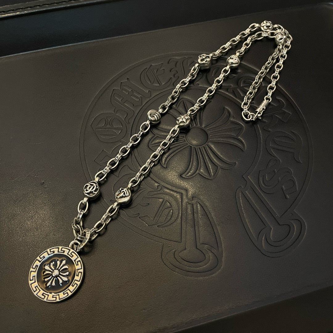 Silver-tone pendant necklace set with circular medallion and ornate chain links