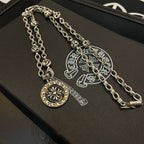 Silver-tone pendant necklace with round sun medallion and curved charm detail