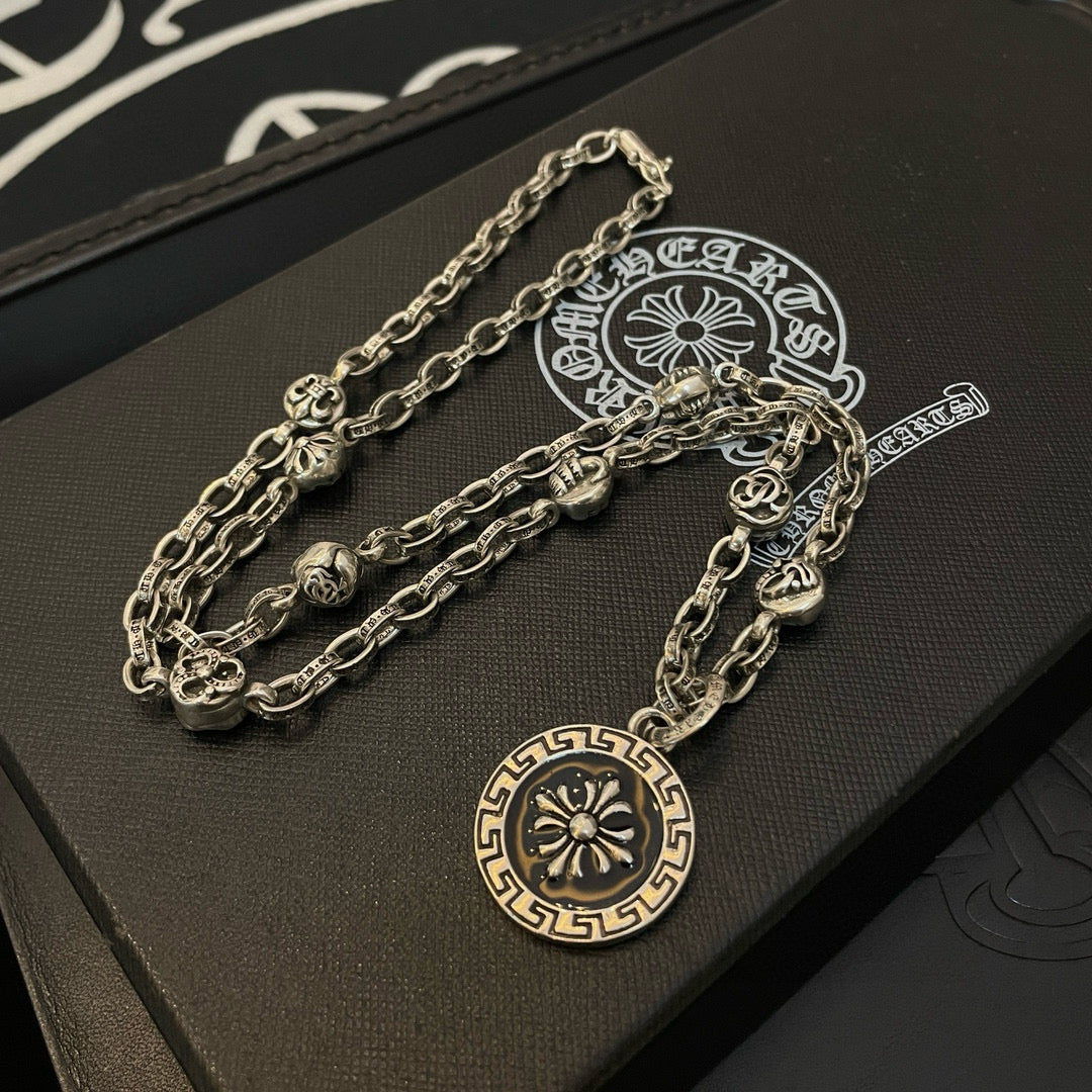 Silver-tone multi-chain pendant necklace with round sun medallion charm