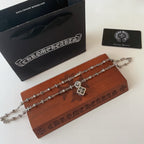 Silver-tone charm necklace with square flower pendant and small floral charm stations