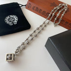 Silver-tone charm necklace with square flower pendant and chain links with bead accents