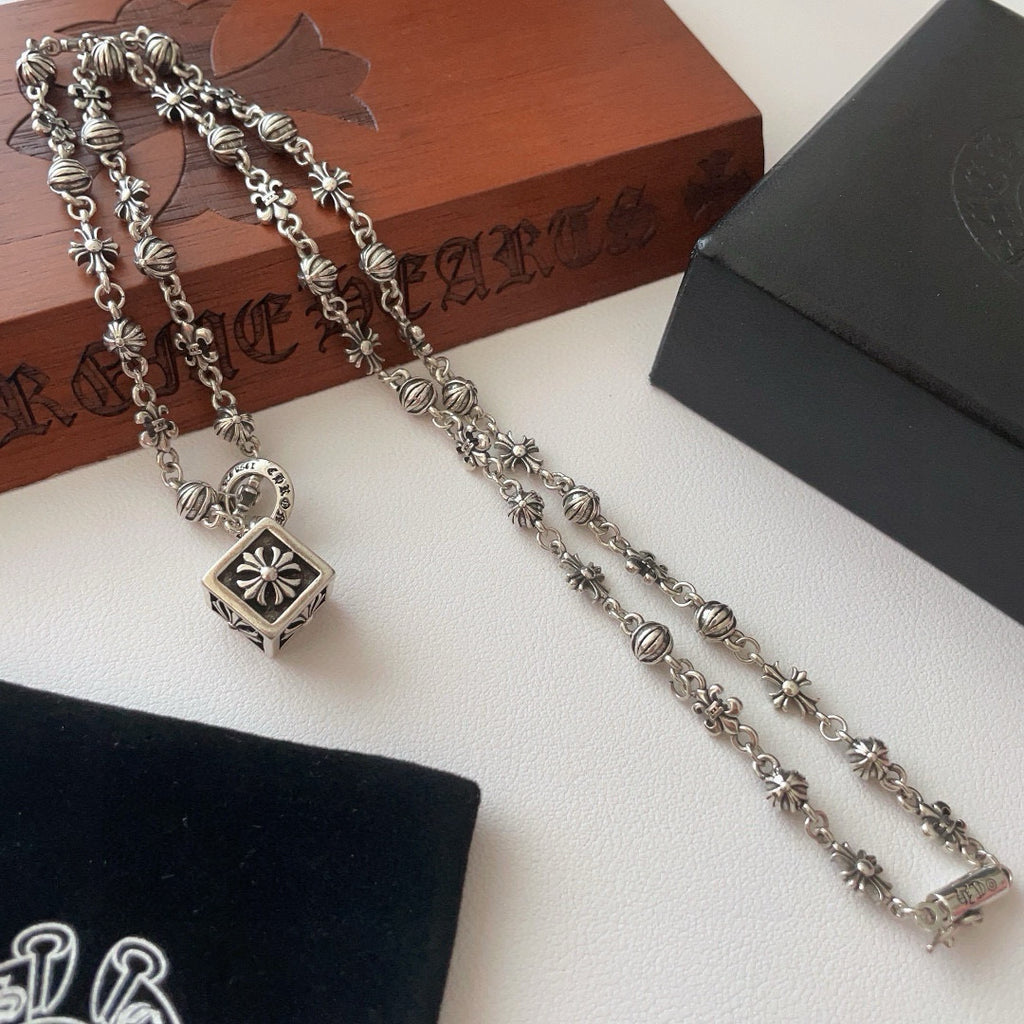 Silver-tone multi-link charm necklace with square flower pendant and small floral charms