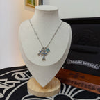 Silver cross pendant necklace with blue gemstone details