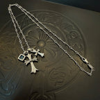 Silver cross pendant necklace with blue gemstone accents on a chain