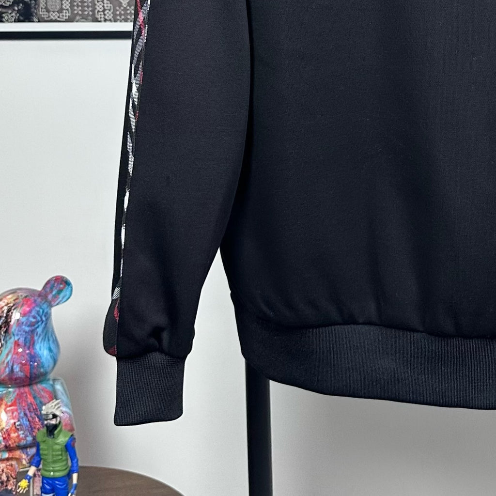 Dark navy hooded zip jacket with ribbed cuffs and part of the side seam