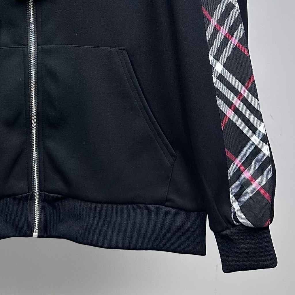 Dark navy zip jacket with front pocket seam and plaid sleeve panel