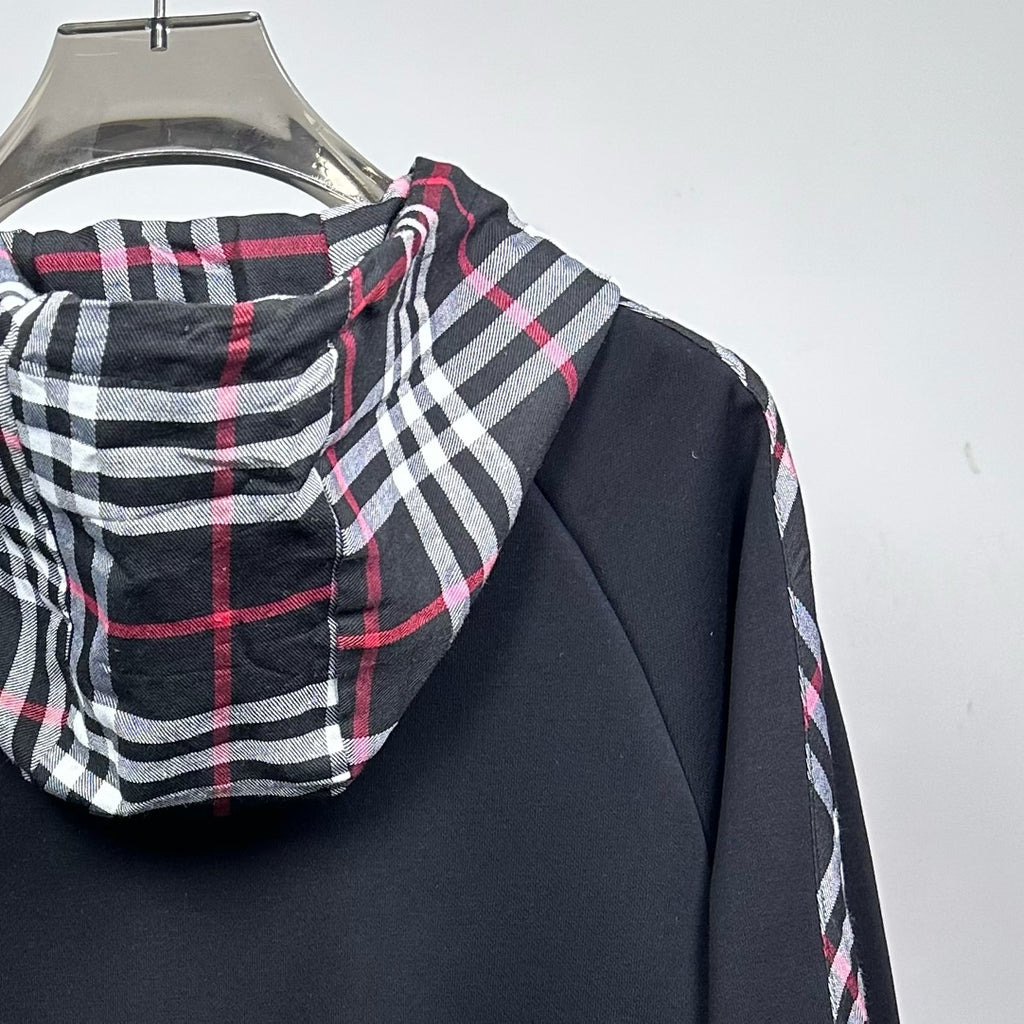 Dark navy jacket shoulder and plaid hood with red and white stripe accents
