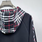 Dark navy jacket shoulder and plaid hood with red and white stripe accents
