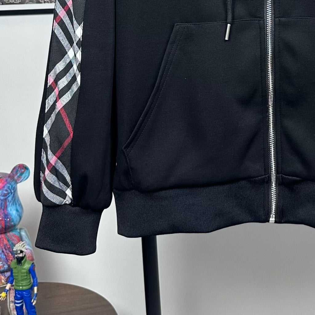 Dark navy hooded zip jacket showing front pocket and ribbed cuffs
