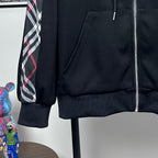 Dark navy hooded zip jacket showing front pocket and ribbed cuffs