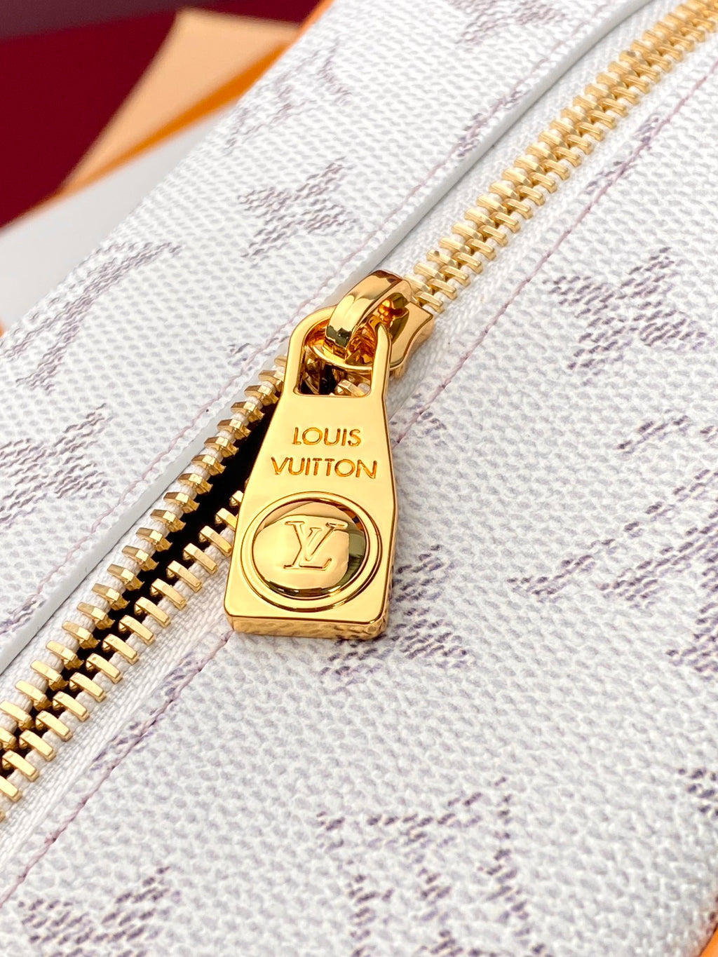 Louis Vuitton zip pouch, white textured fabric with gold zipper pull and logo charm
