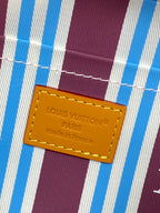 Louis Vuitton crossbody bag interior label on blue-and-white striped lining