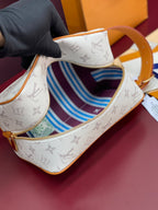 Louis Vuitton crossbody bag open view showing blue striped fabric lining and gold zipper