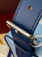 Louis Vuitton light blue monogram bag closeup of gold clasp hardware and strap loop