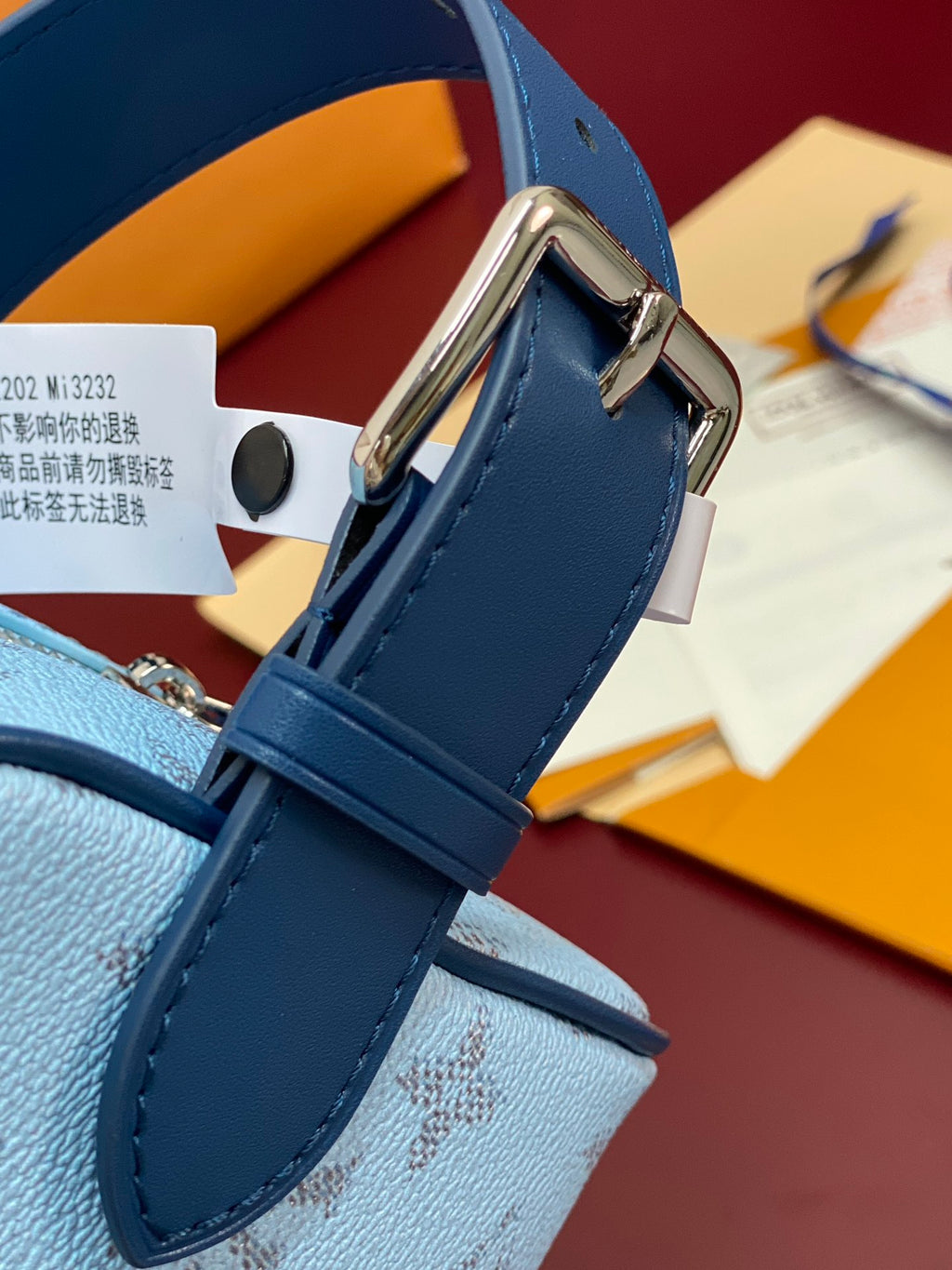 Louis Vuitton light blue monogram bag with blue adjustable strap and metal buckle