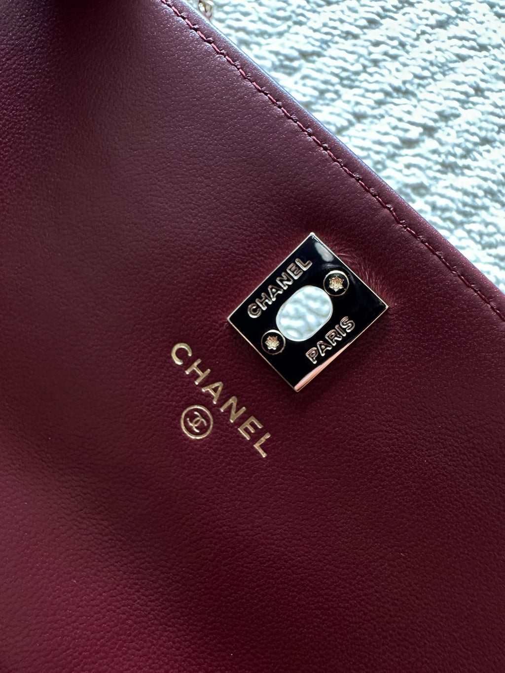 Burgundy leather bag with Chanel Paris logo plate and gold-tone rivets