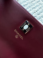Burgundy leather bag with Chanel Paris logo plate and gold-tone rivets