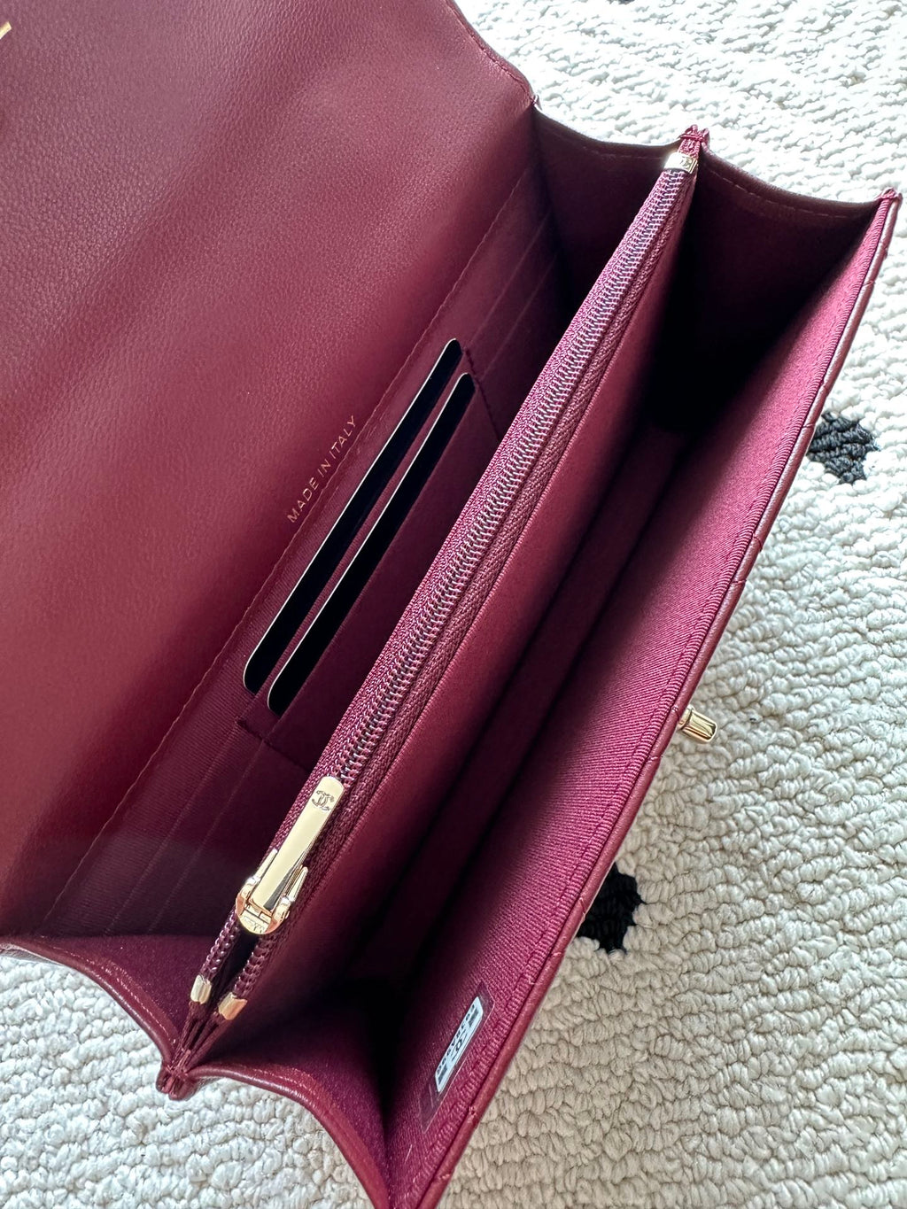 Burgundy leather shoulder bag interior with card slots and clasp