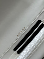 White leather flap bag showing 'MADE IN ITALY' near a card slot.