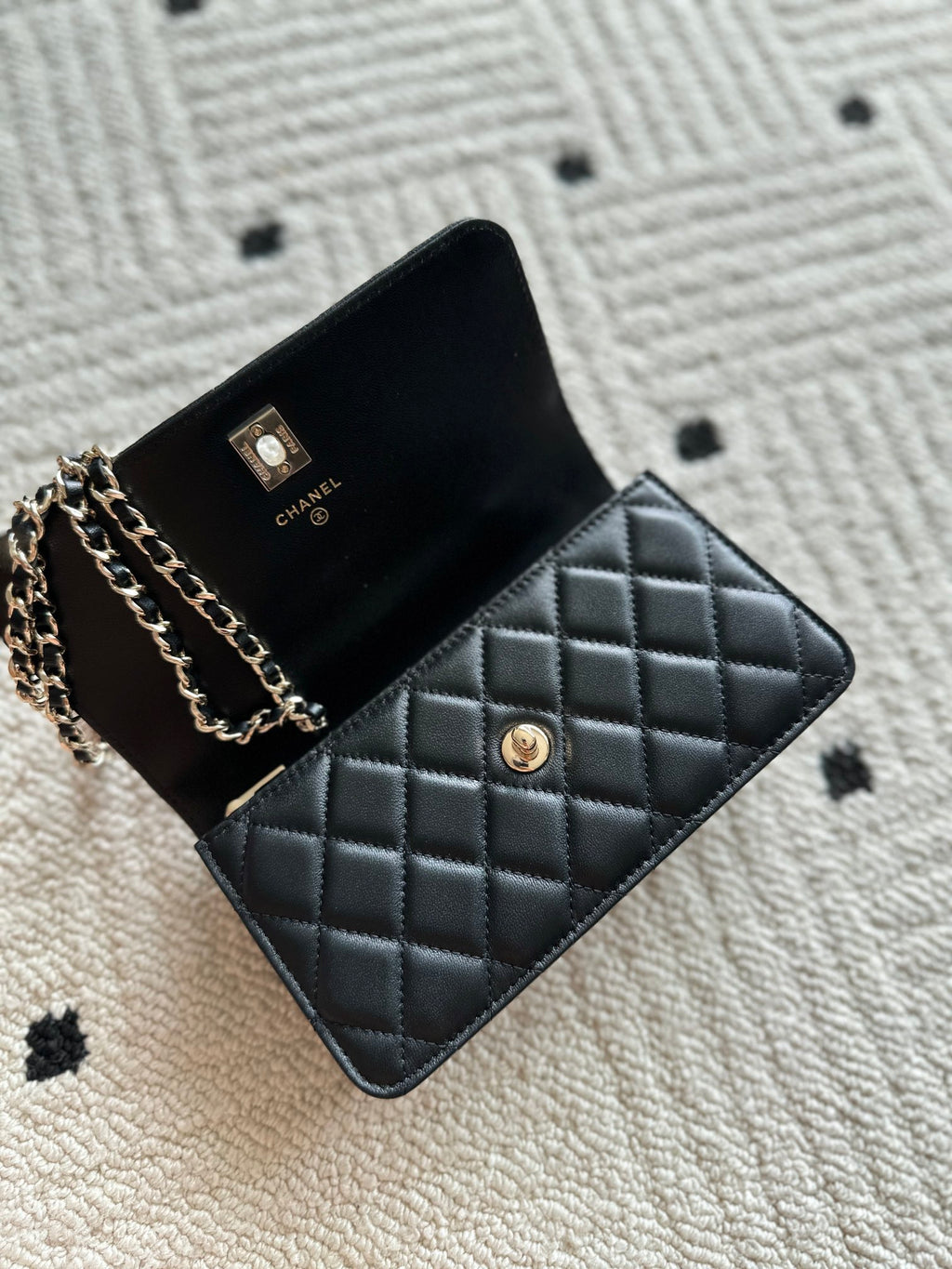 Chanel black quilted flap bag with chain strap and gold button detail