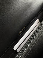 Chanel black bag interior label reading “MADE IN ITALY” near zipper