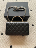 Chanel mini black quilted flap bag with round handle and chain strap