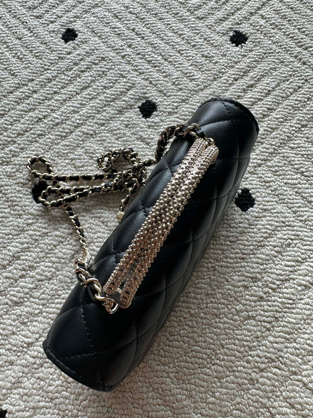 Chanel black quilted mini shoulder bag with chain strap and metal hardware close-up