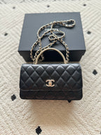 Chanel mini black quilted flap bag with chain strap and gold CC logo